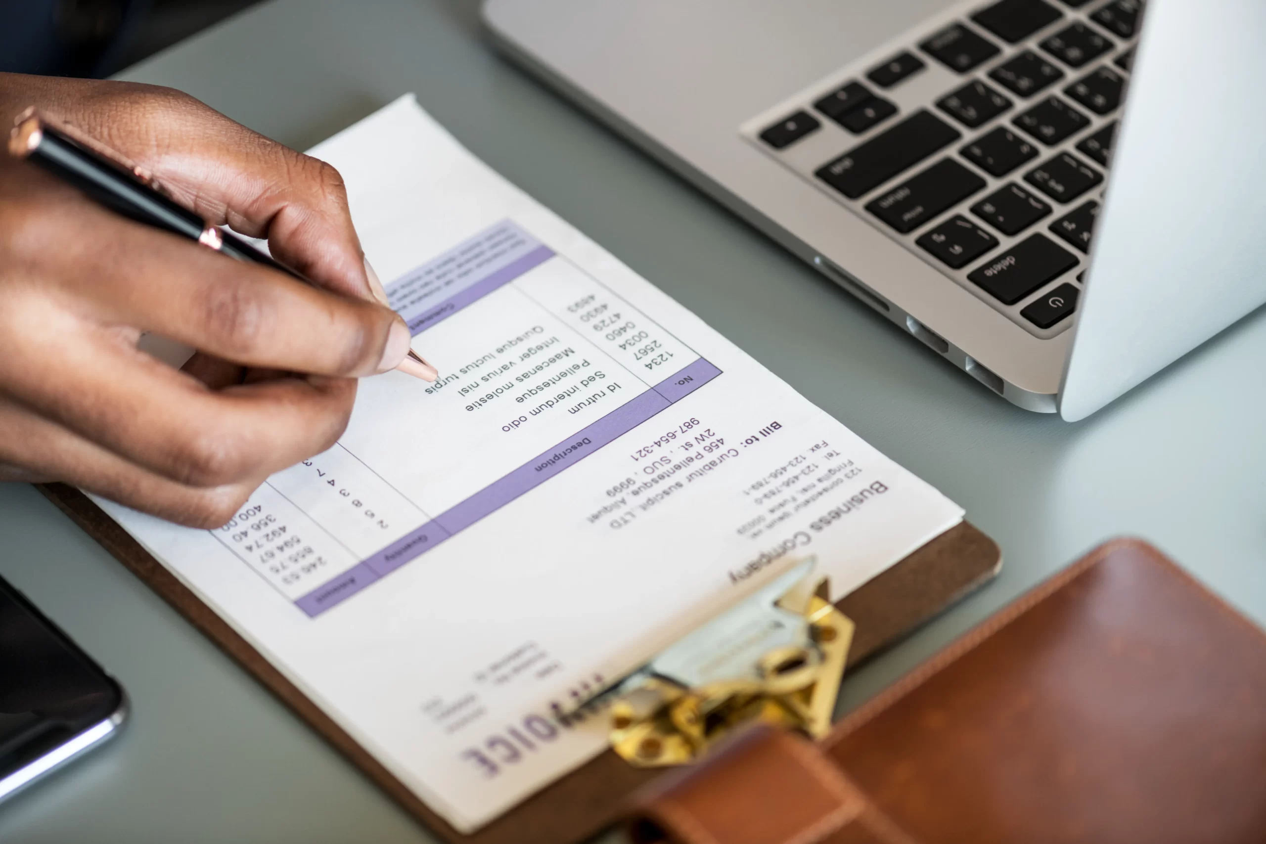 closeup-of-business-man-checking-tax-invoice-paper
